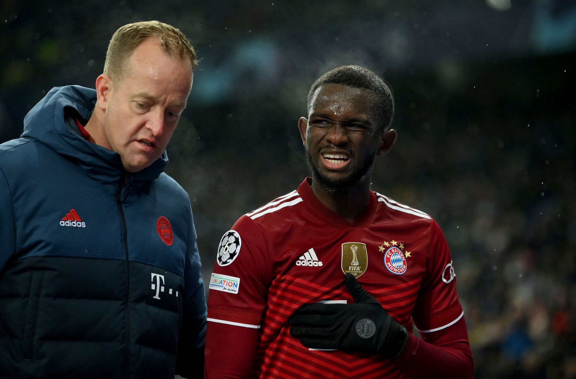 Bayern Munich defender Tanguy Nianzou (right) with a coaching staff member