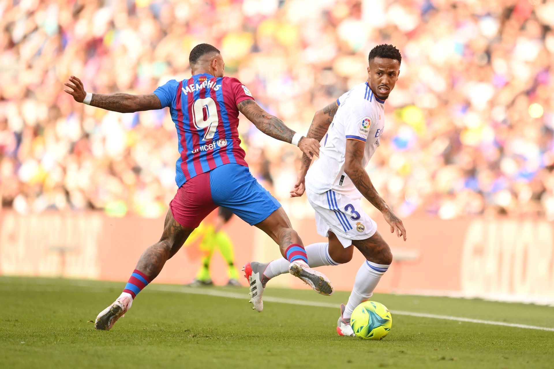 Real Madrid&#039;s Eder Militao (#3) gets past Memphis Depay (#9) of Barcelona