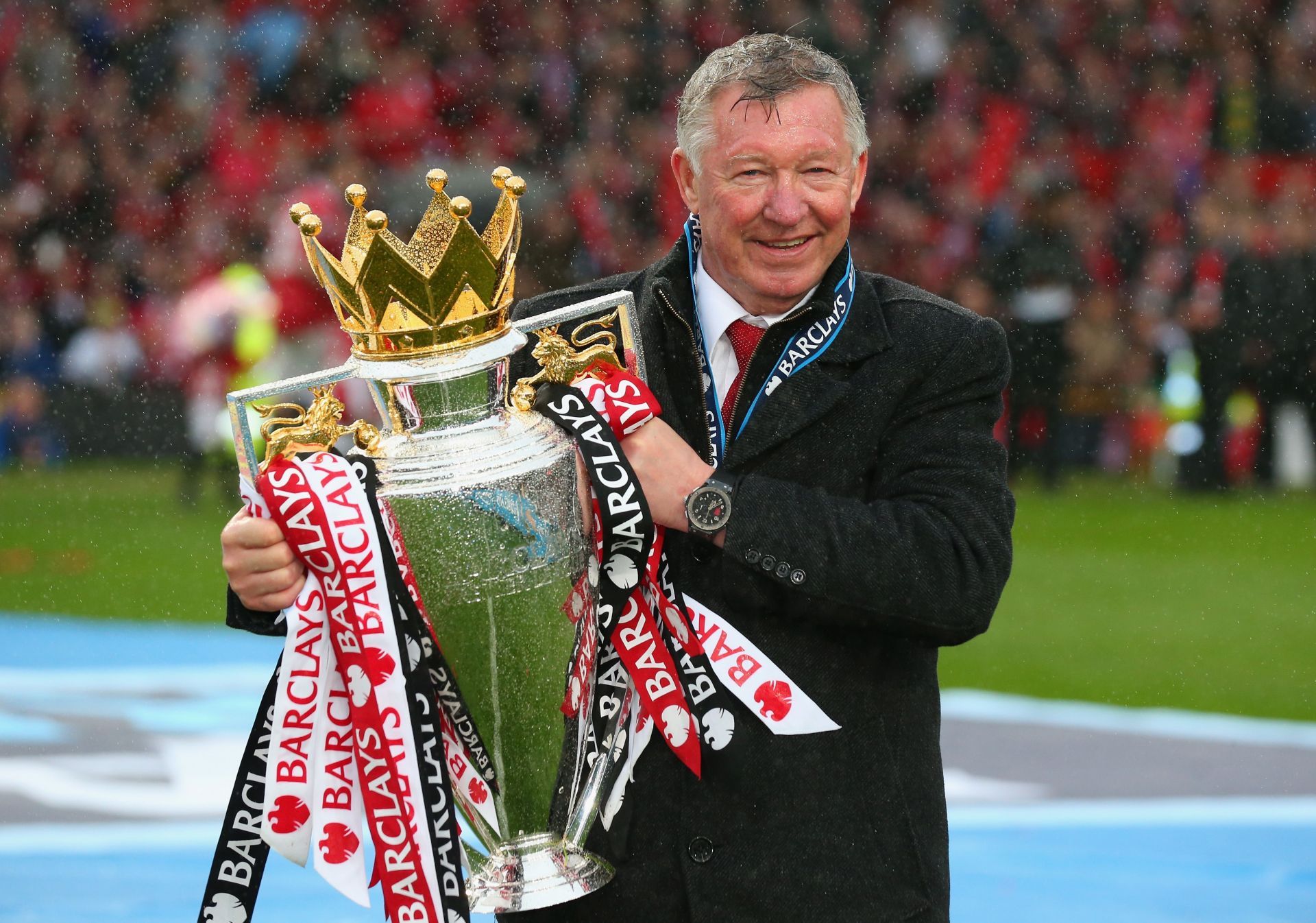Sir Alex Ferguson poses with the Premier League trophy