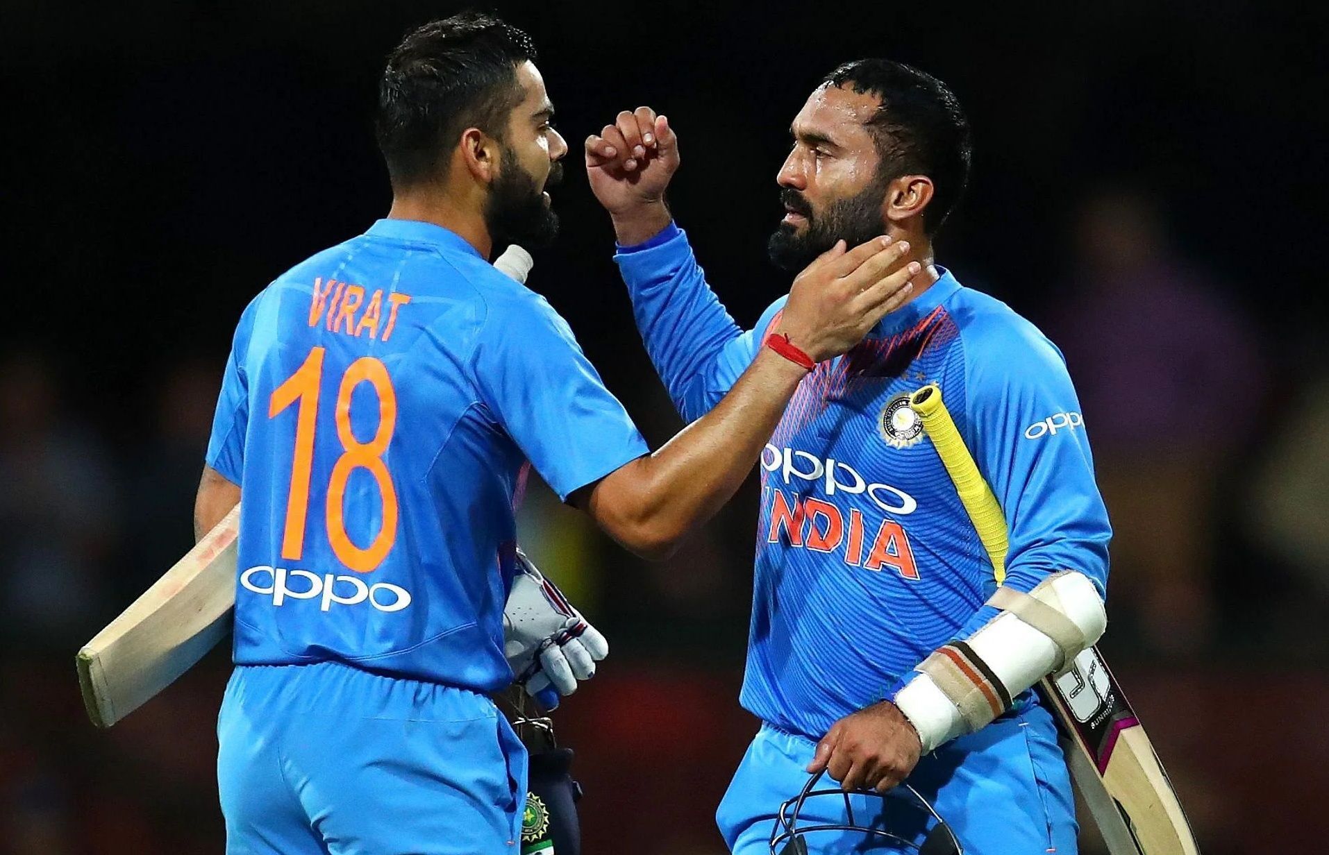 Virat Kohli (left) and Dinesh Karthik after a T20I against Australia in 2018. Pic: Getty Images