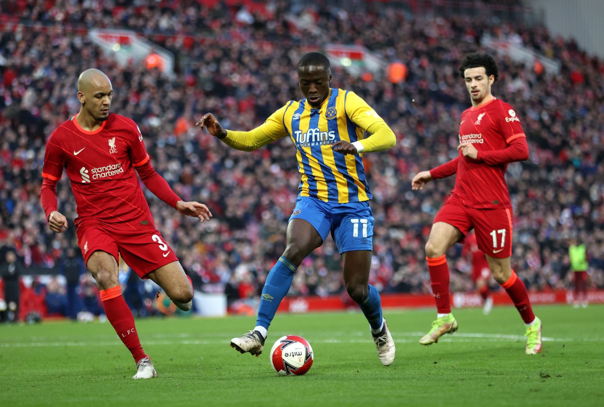 Daniel Udoh tussles it out with Fabinho.