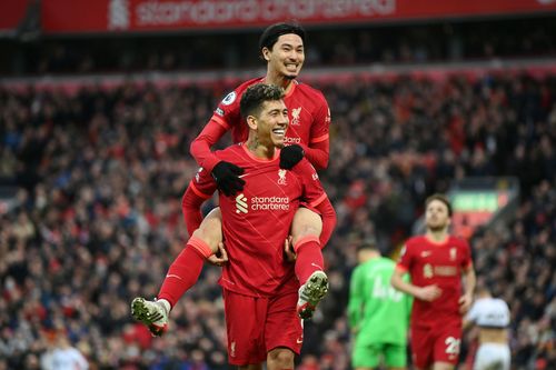 Takumi Minamino celebrates his goal with Roberto Firmino.