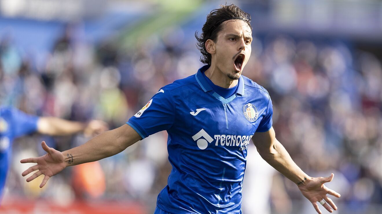 Enes Unal celebrates after scoring a goal.