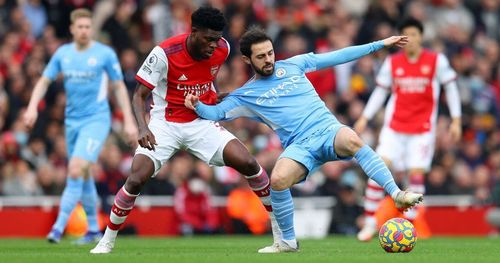 Bernardo Silva vies with Thomas Partey for the ball