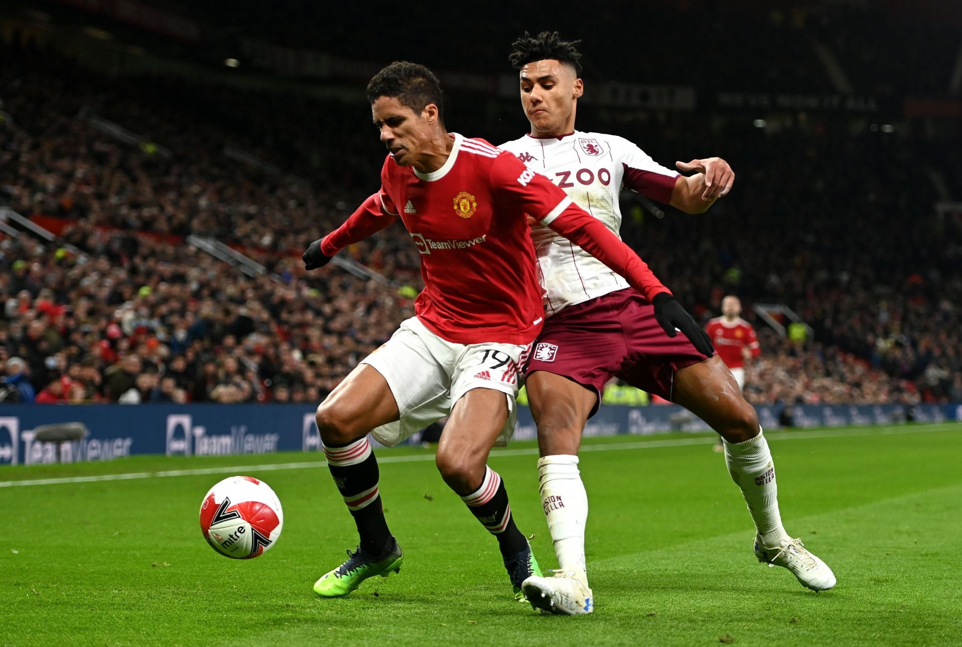 Raphael Varane of Manchester United holds off Ollie Watkins of Aston Villa