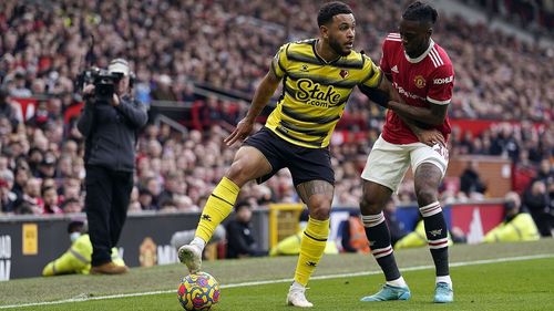 A Watford player fights for the ball with Aaron Wann-Bissaka