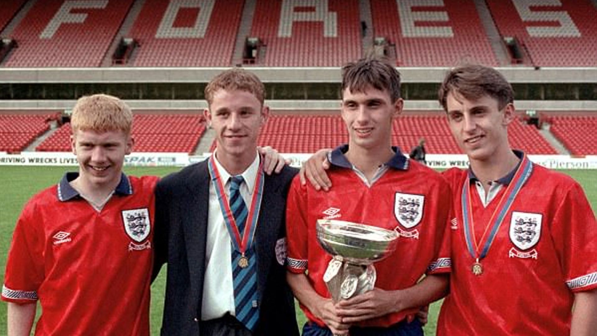 Chris Casper holding the U18 European Championship trophy alongside Paul Scholes, Nicky Butt and Gary Neville.
