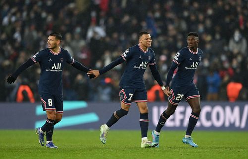 Paris Saint-Germain players take a victory lap in front of their fans after beating Real Madrid at the Parc des Princes on Tuesday night