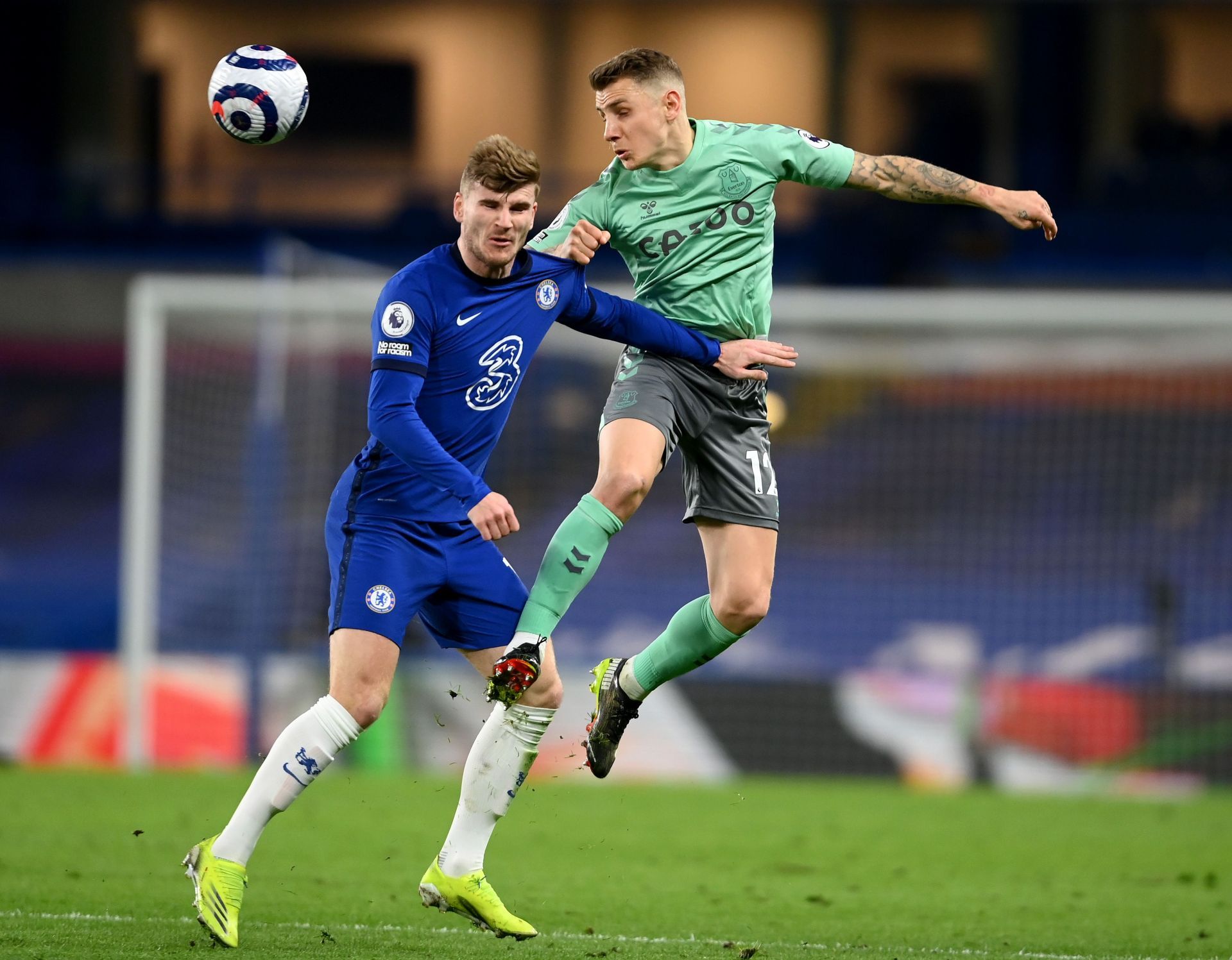 Lucas Digne (R, #12) heads away from Timo Werner (L).