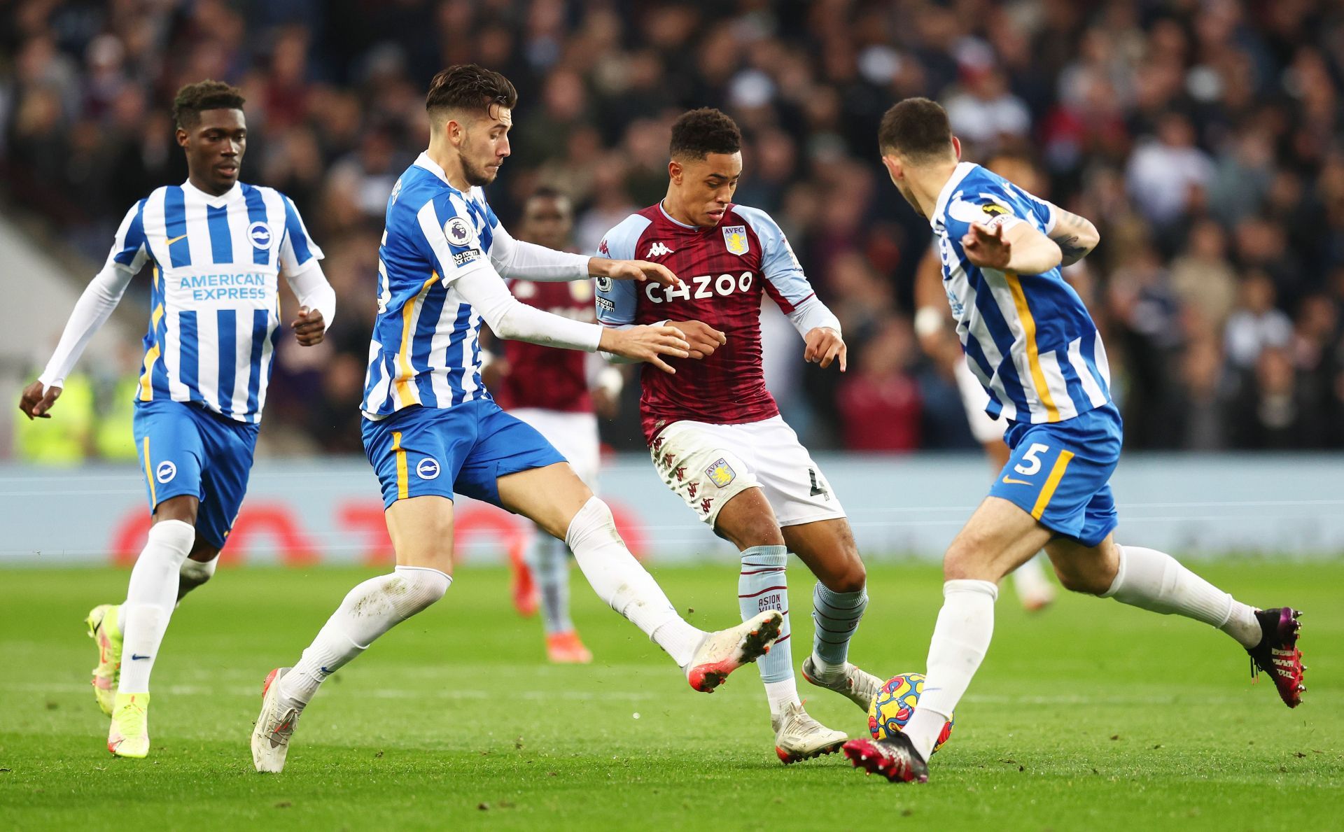 Jacob Ramsey of Aston Villa battles for possession with Lewis Dunk and Jakub Moder of Brighton