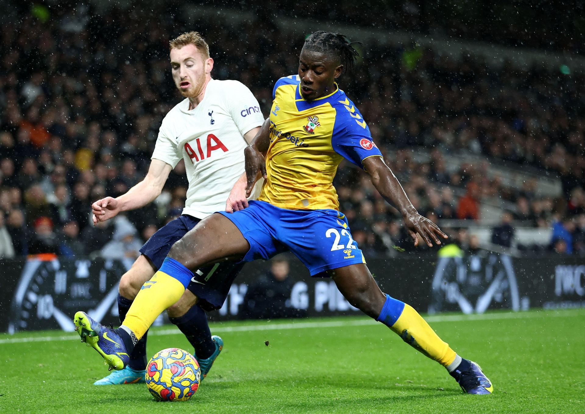 Salisu (right) protects the ball under pressure from Dejan Kulusevski (Spurs)