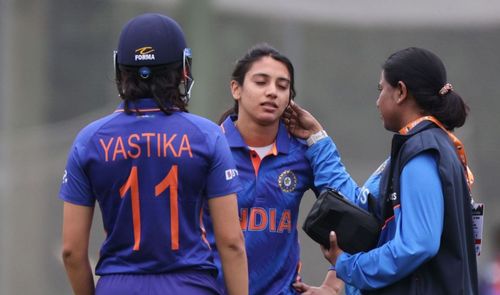 Team physio checking Smriti Mandhana after she took a blow to the helmet. Getty Images