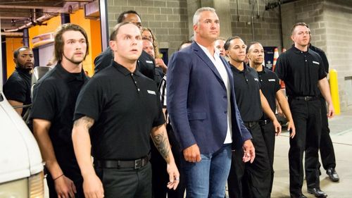 Shane McMahon with WWE's security personnel backstage