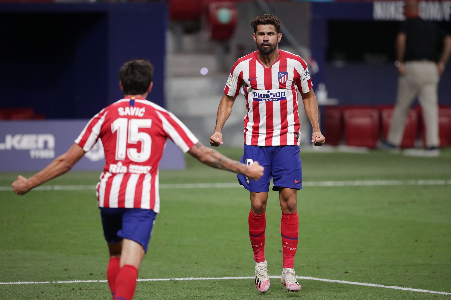 Diego Costa (right) celebratres with Stefan Savic (#15) of Atletico Madrid.