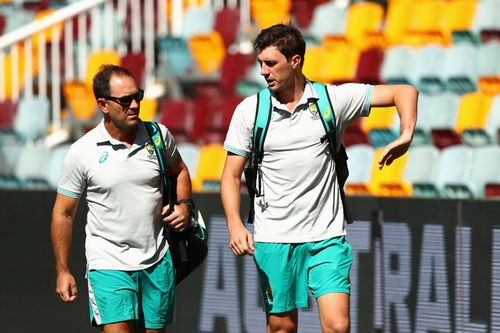 Justin Langer (L) and Pat Cummins. (Image: Getty)