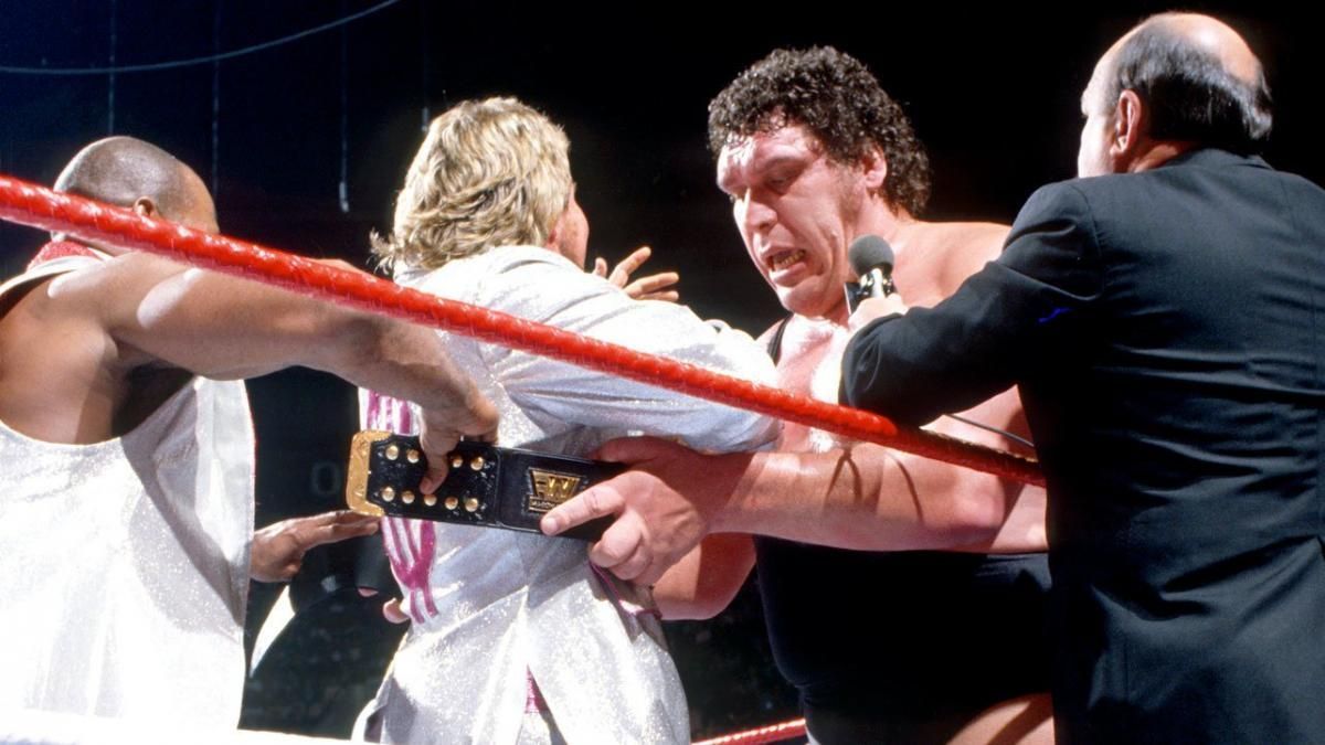 Andre The Giant wraps the WWE Championship around The Million Dollar Man's waist