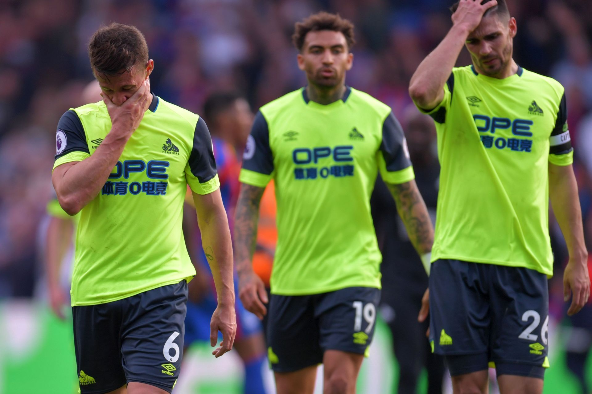 Huddersfield players react after losing to Crystal Palace