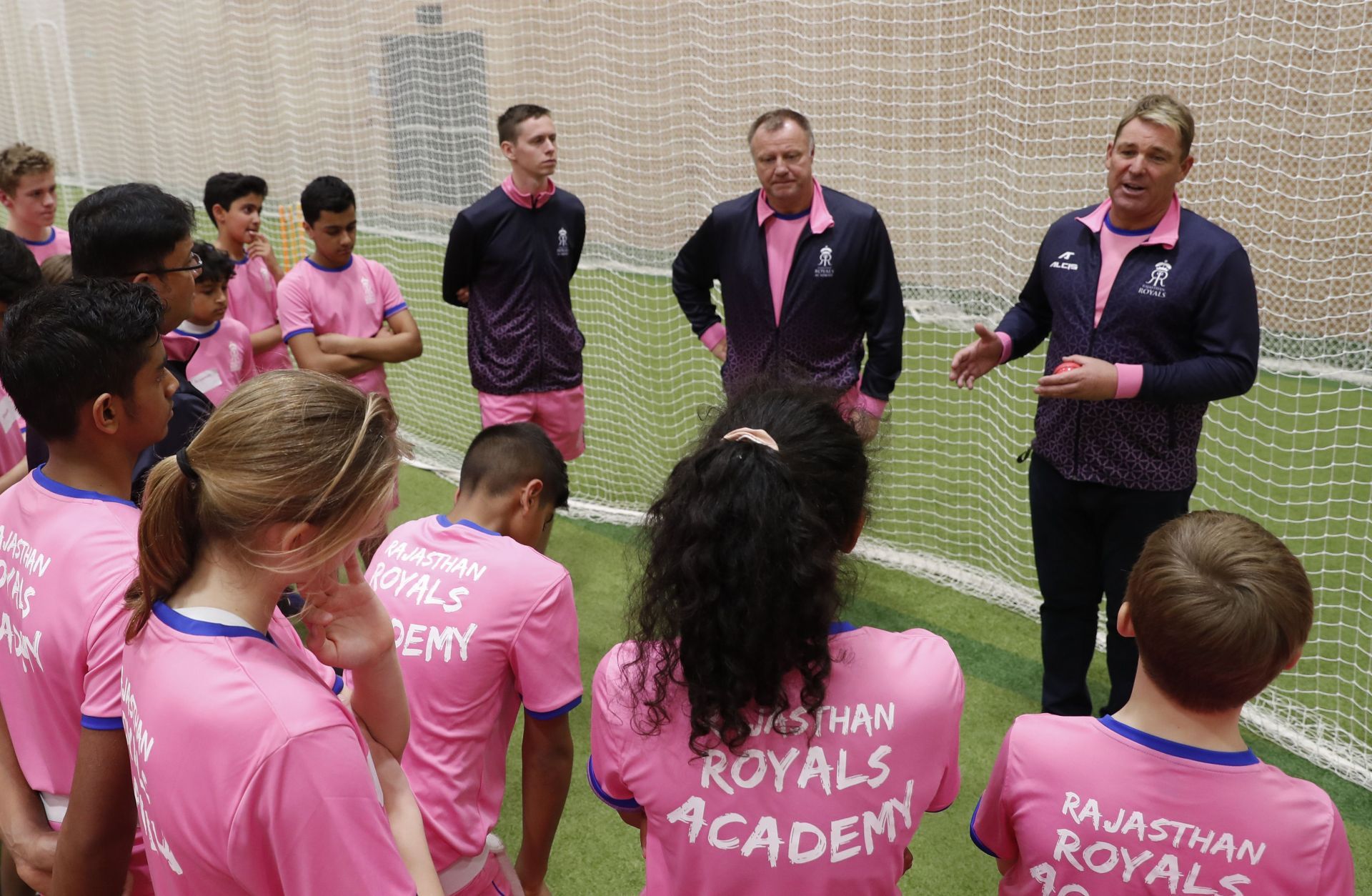 Shane Warne interacting with children