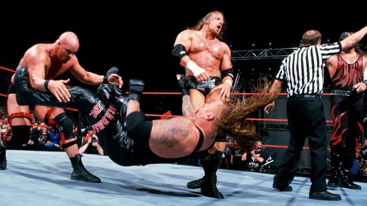 Austin and Triple H attack The Undertaker behind the referee's back