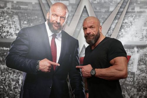 WWE Hall of Famer Triple H poses with an image of himself