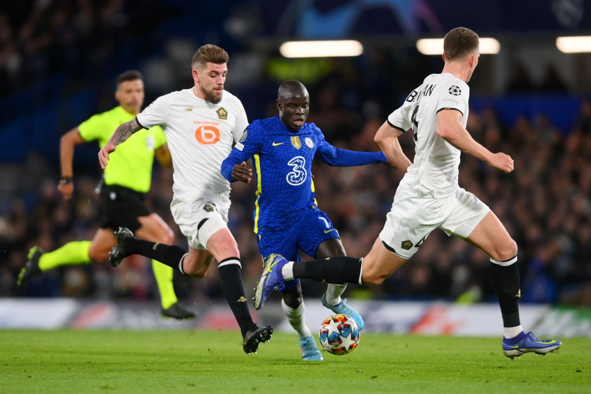 Kante battles two Lille OSC players for possession in an earlier game