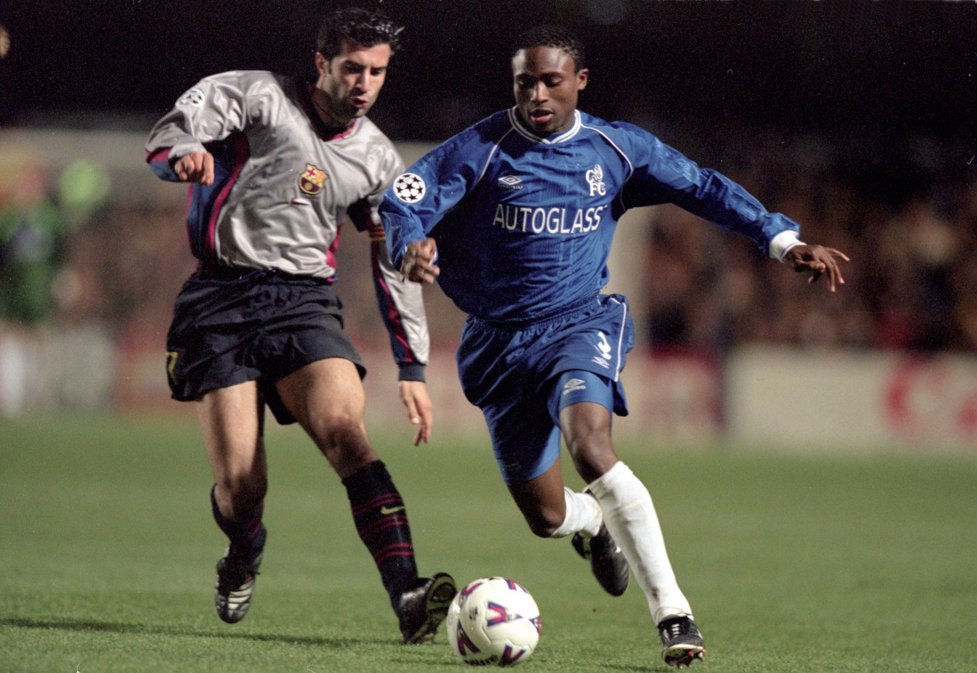 Celestine Babayaro of Chelsea is chased by Luis Figo of Barcelona