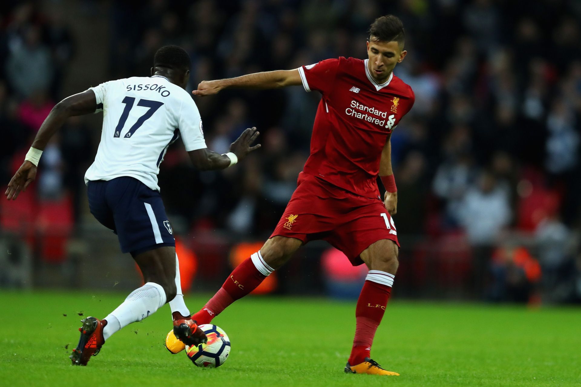 Marko Grujic (R) in action against Tottenham Hotspur