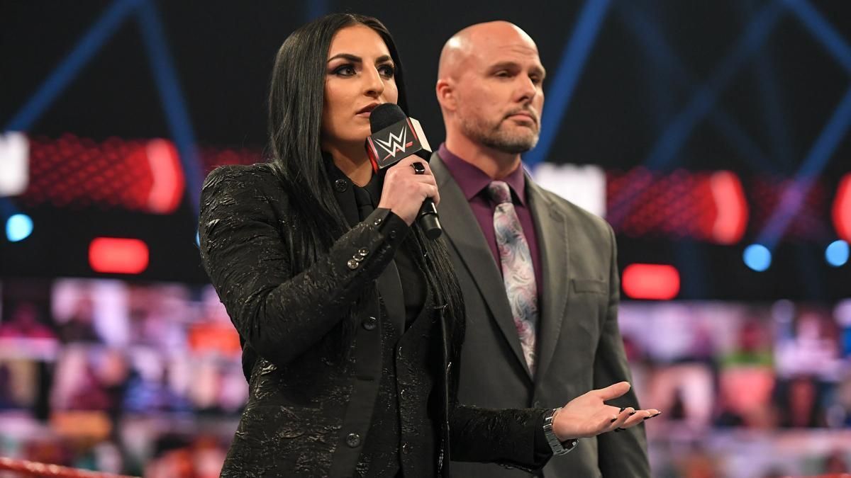 Sonya Deville alongside Adam Pearce.