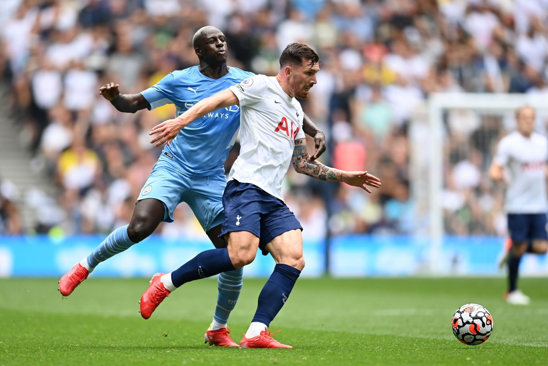 Benjamin Mendy (L) grapples with Pierre-Emile Hojberg of Tottenham Hotspur (R).