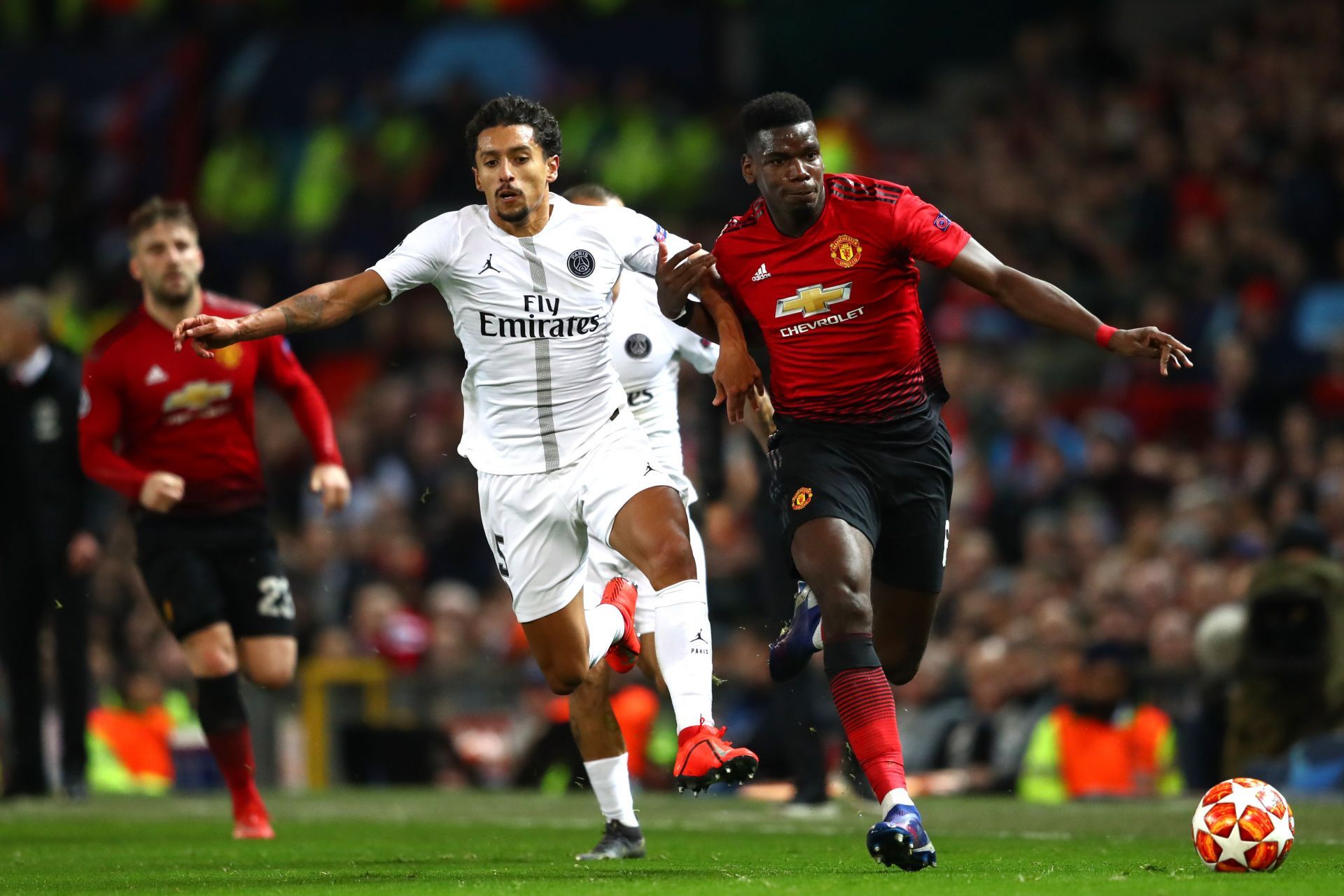 PSG skipper Marquinhos (L) battles Paul Pogba of Manchester United (R).