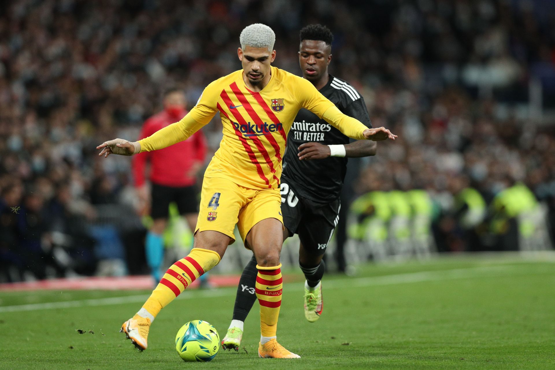 Ronald Araujo (#4) holds off Vinicius Jr. of Real Madrid.