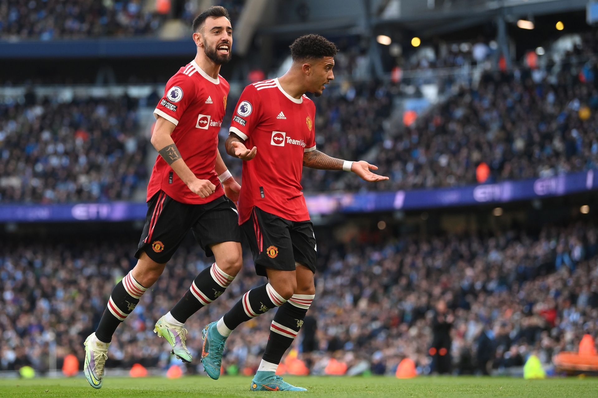 Manchester United&#039;s Bruno Fernandes (L) and Jadon Sancho (R) celebrate at the Etihad