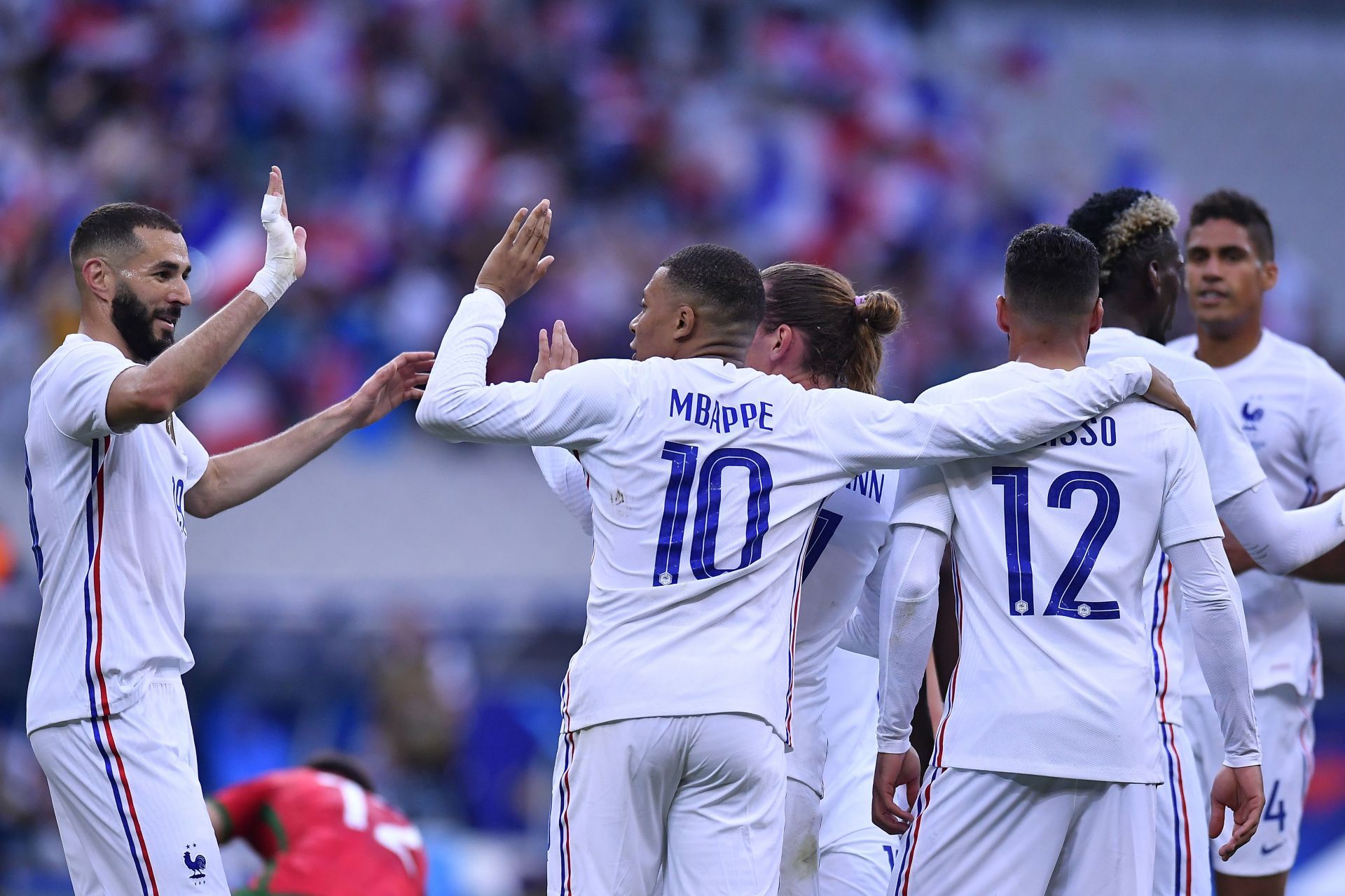 French footballer Kylian Mbappe celebrates with his teammates in a match
