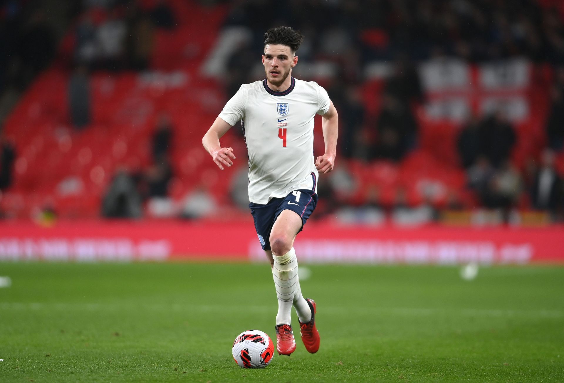 Declan Rice drives forward with the ball from midfield.