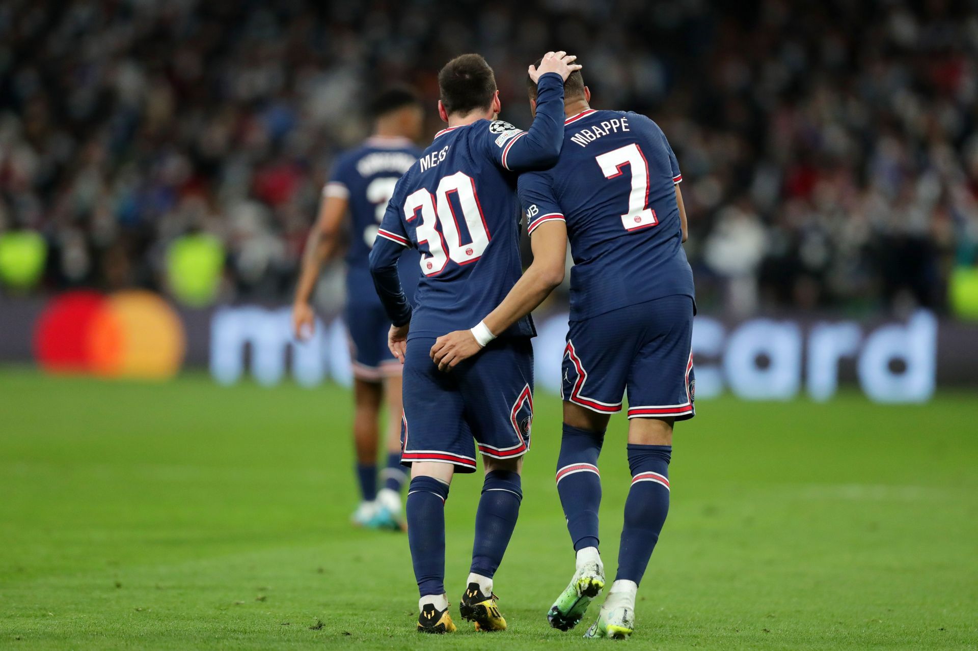 Kylian Mbappe celebrates with Lionel Messi.