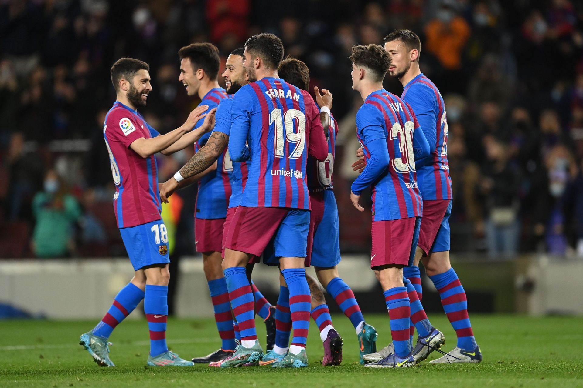 Barcelona players rejoice after scoring a goal.