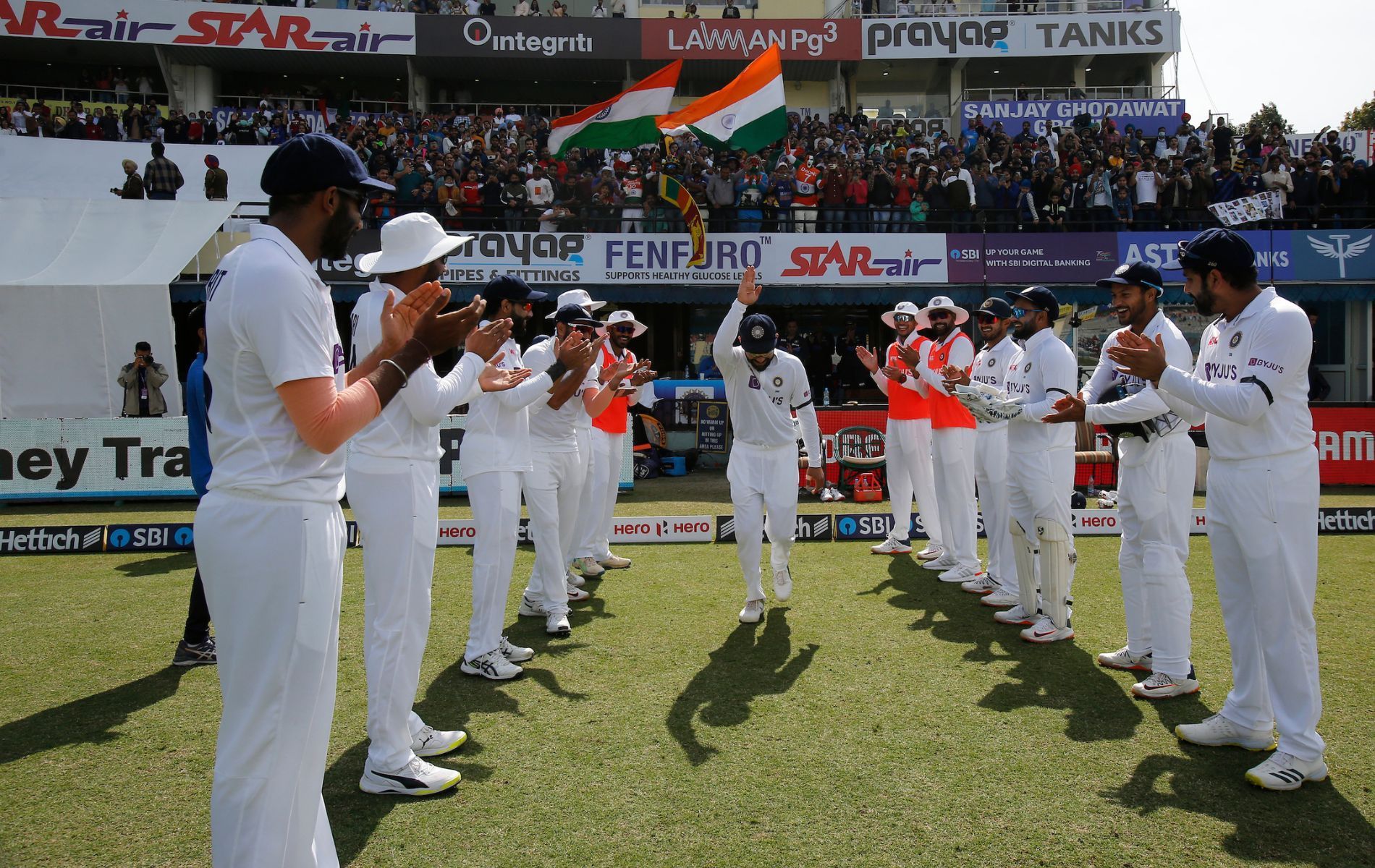 Virat Kohli gets a guard of honour from his teammates on Day 2 of the 1st Test vs Sri Lanka. (PC: BCCI)