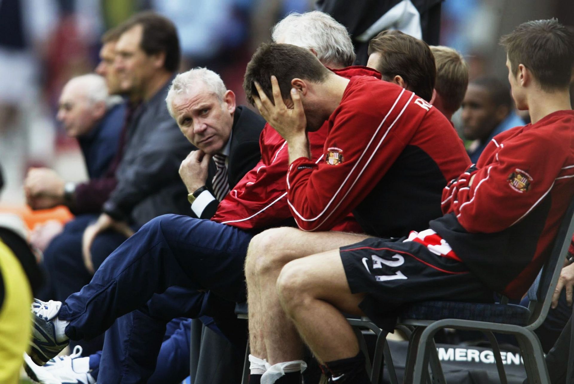 Sunderland manager Peter Reid looks on as Niall Quinn of Sunderland holds his head