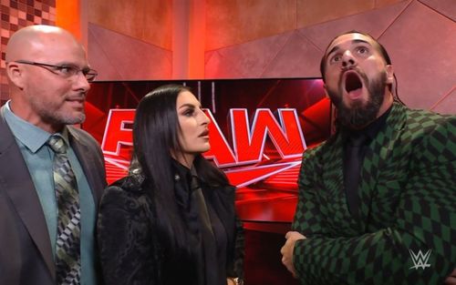 Adam Pearce and Sonya Deville backstage with Seth Rollins