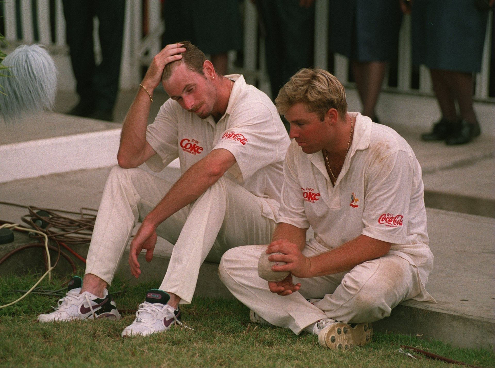 Paul Reiffel (left) and Shane Warne look dejected after Australia’s loss to West Indies in a Test match in Trinidad. Pic: Getty Images