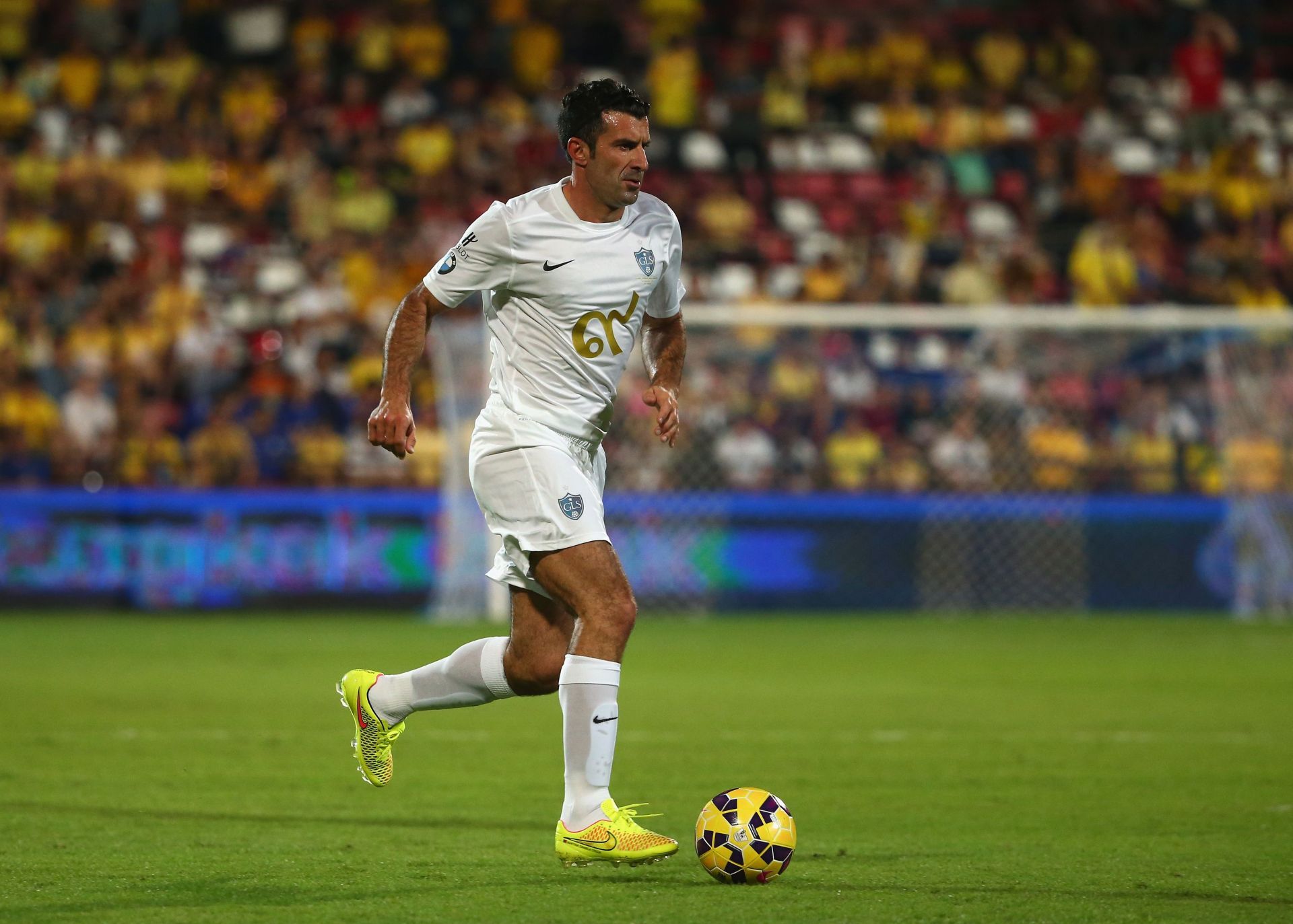 Luis Figo embarks on a run during a Global Legend Series game.