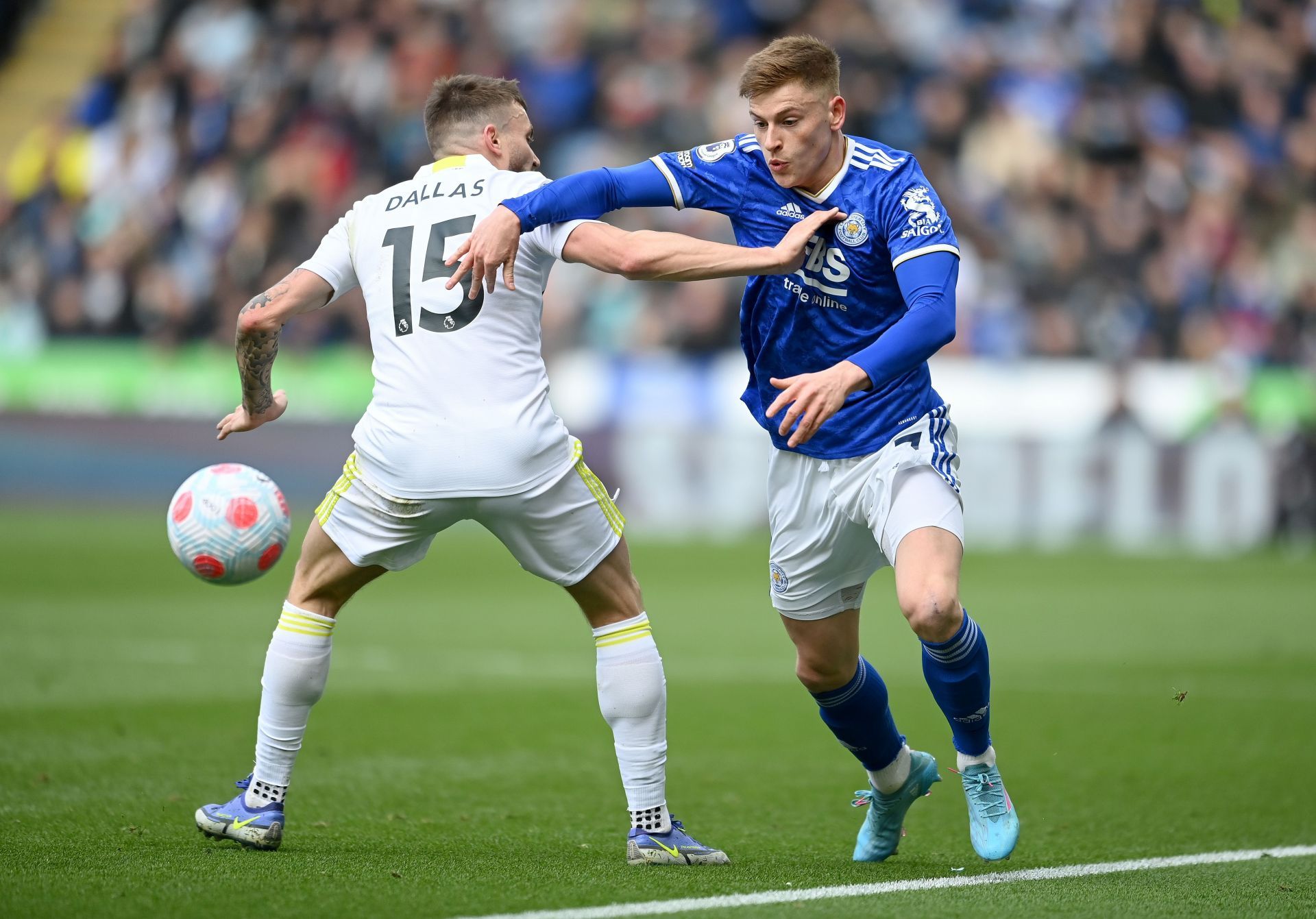 Leicester City's Harvey Barnes (right) gets past Leeds United's Stuart Dallas.