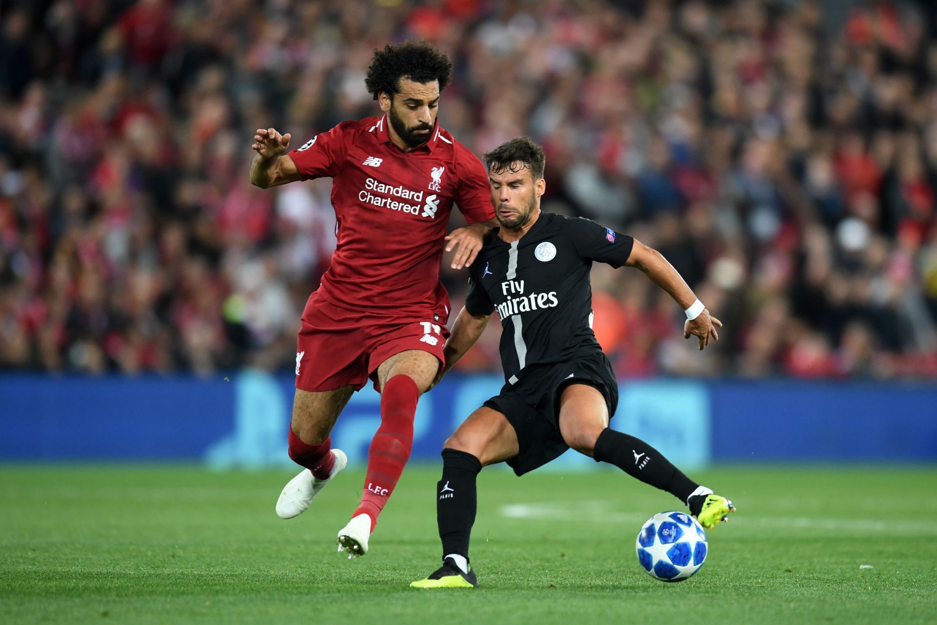 Liverpool's Mohamed Salah (left) in action against PSG