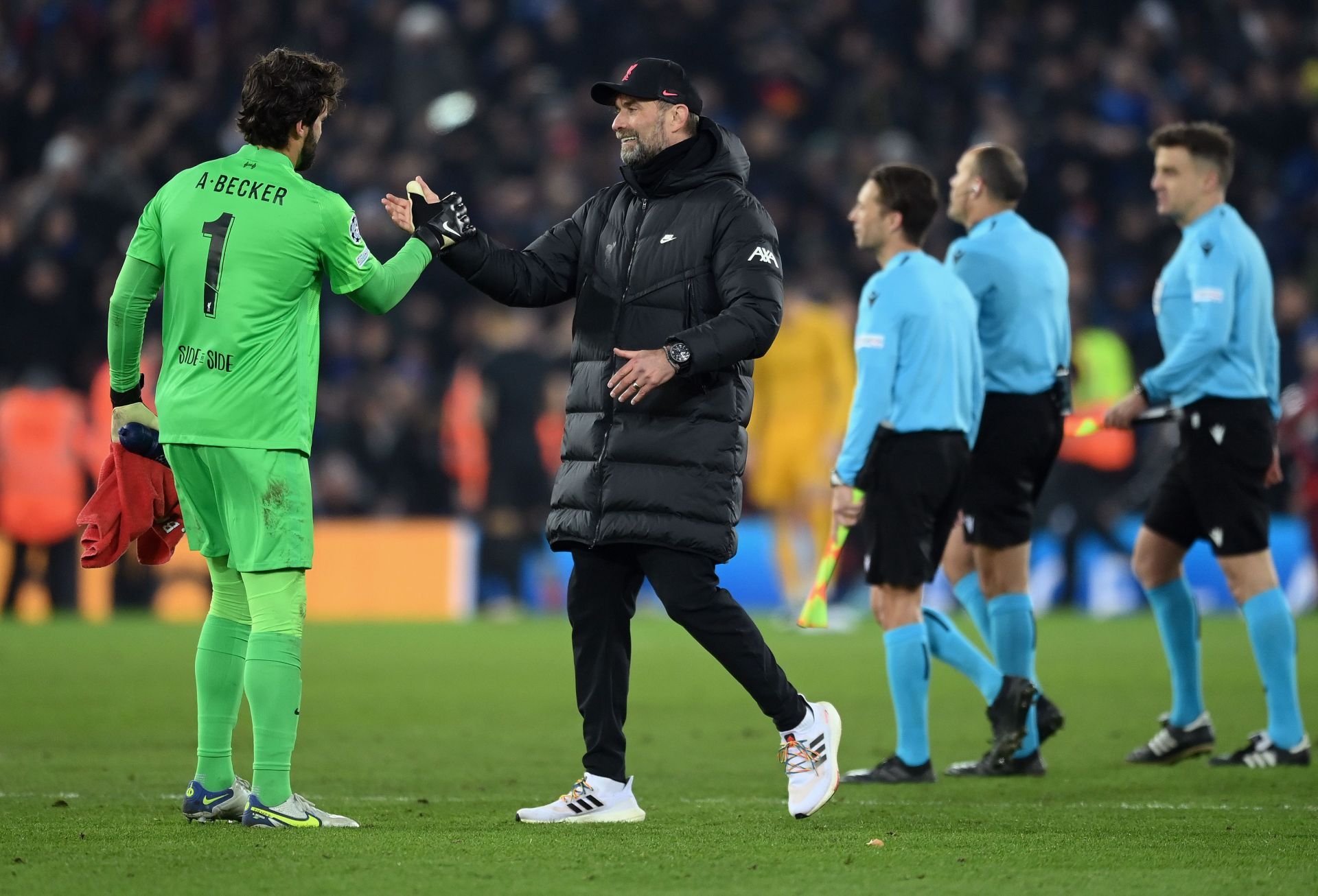 Liverpool manager Jurgen Klopp (r) and goalkeeper Alisson celebrate after sealing their progress into the Champions League quarterfinals