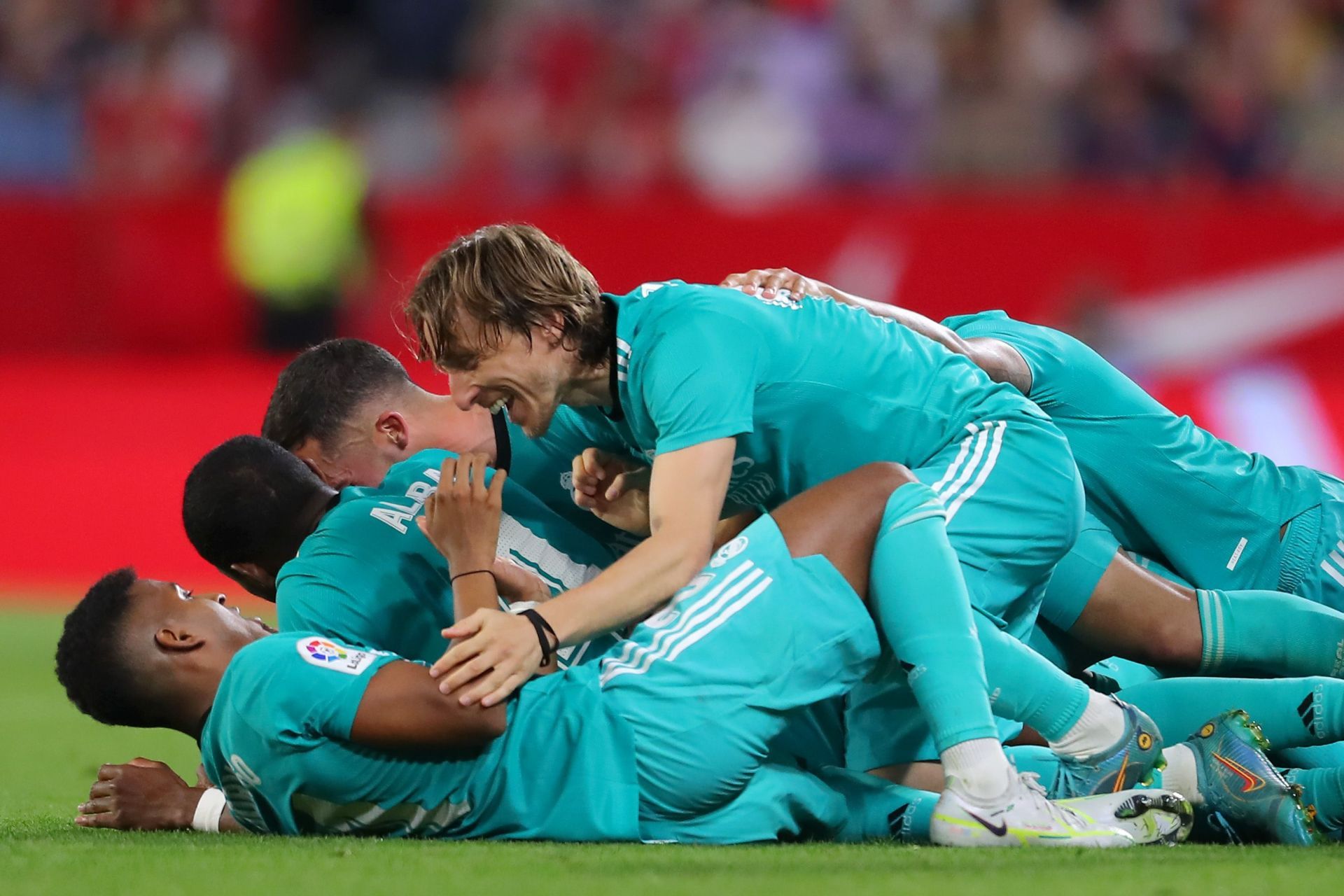 Real Madrid players celebrate after scoring a goal.