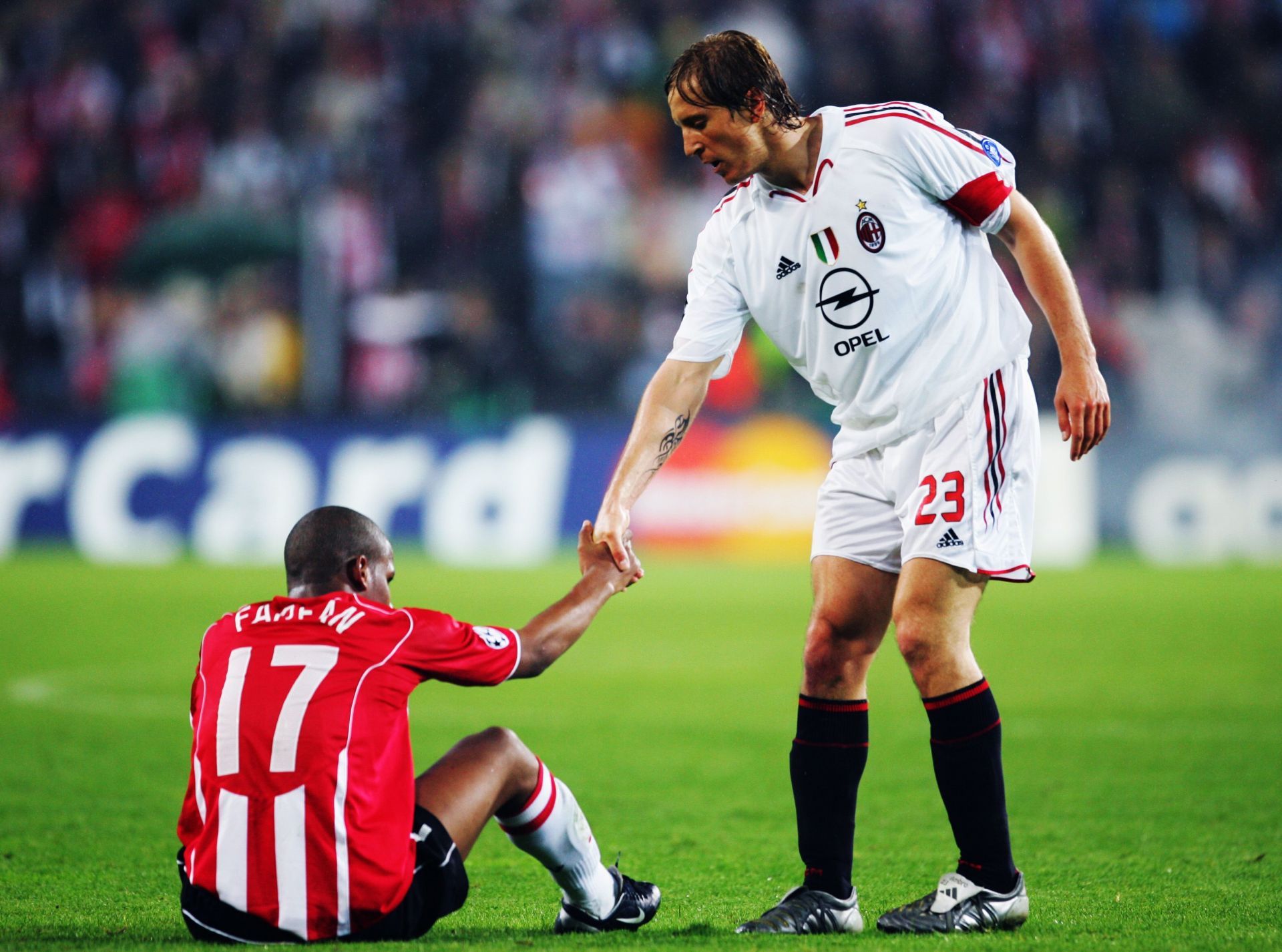 Massimo Ambrosinio of AC Milan consoles Jefferson Farfan of PSV Eindhoven following the 2005 UEFA Champions League Semi Final, 2nd Leg