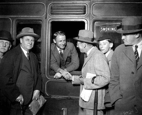 Don Bradman looking out of a railway coach but it was Bill O'Reilly who fortutiously hopped off a train for his first encounter with young Don