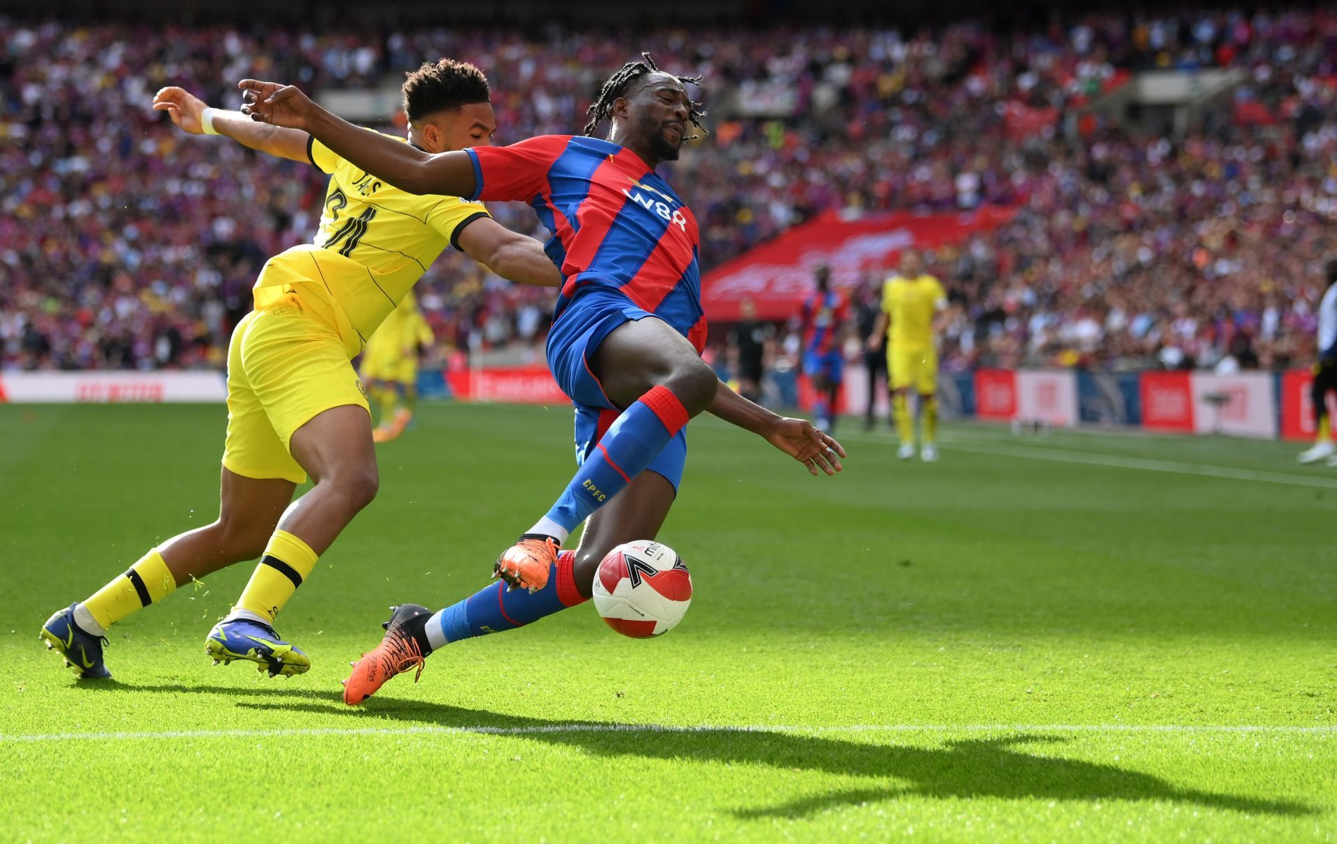 Jean-Philippe Mateta (C) vies with Reece James (yellow)