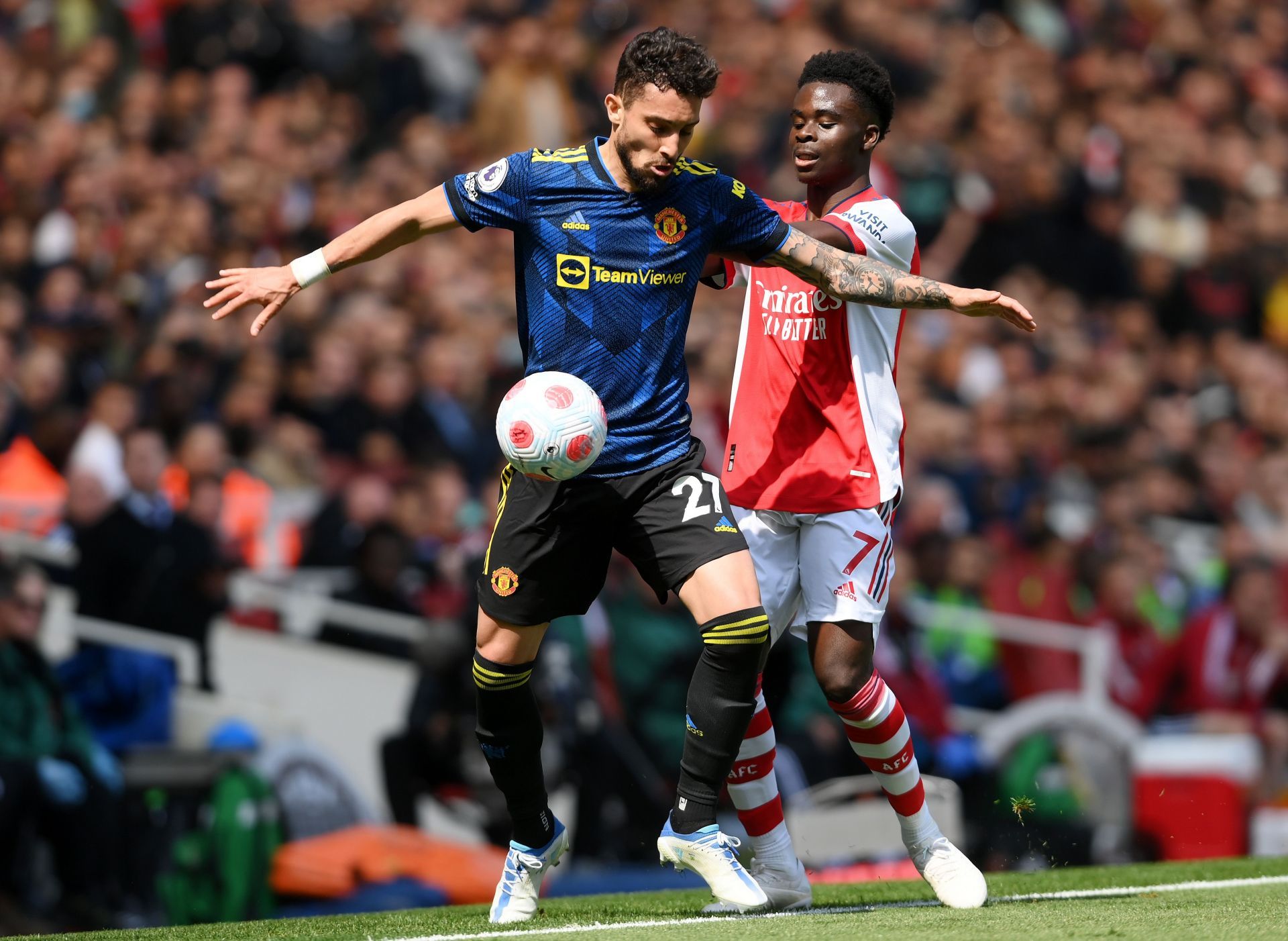 Alex Telles tussles it out against Bukayo Saka.