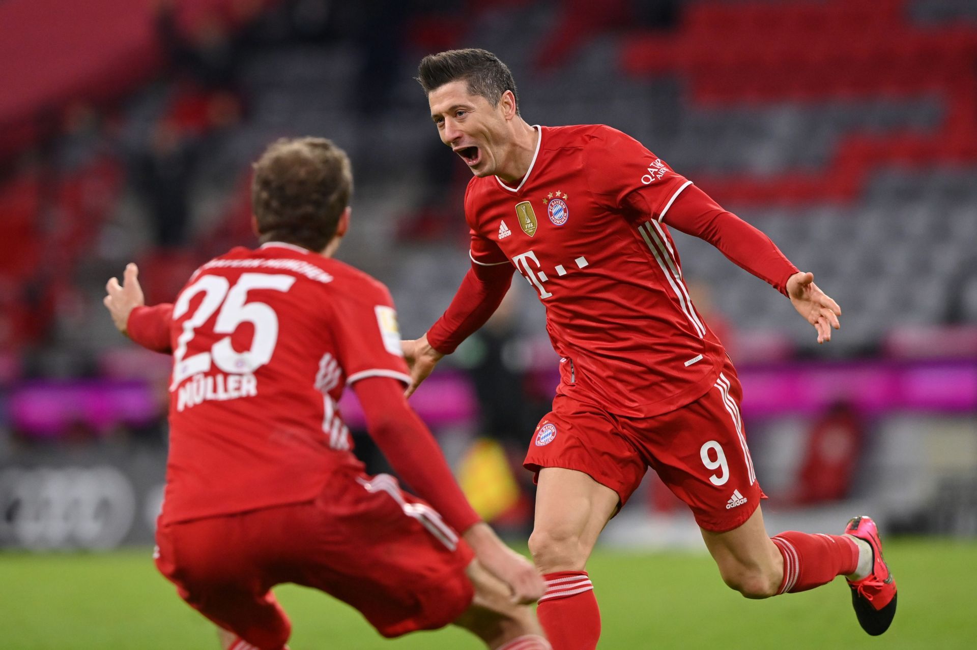 Robert Lewandowski (#9) and Thomas Muller (#25) celebrate a goal against Borussia Dortmund.